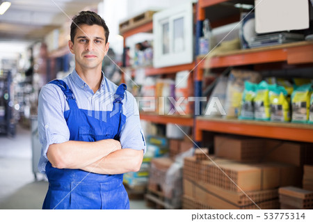 Portrait of adult male seller in uniform at workplace Portrait of adult male seller in uniform at workplace 53775314