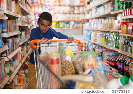 boy with cart in hypermarket 53775315