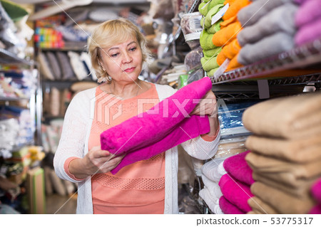 elderly woman with bath towel in the shop elderly woman with bath towel in the shop 53775317