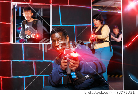 Portrait of cheerful African-American with laser gun having fun 53775331
