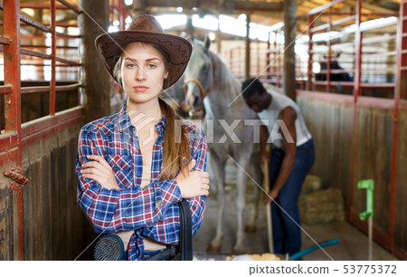 Portrait of woman horse farm worker Portrait of woman horse farm worker 53775372