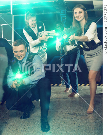 men and women co-workers having corporate entertainment 53775373