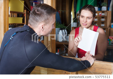 Athletic man talking to girl at reception Athletic man talking to girl at reception 53775511