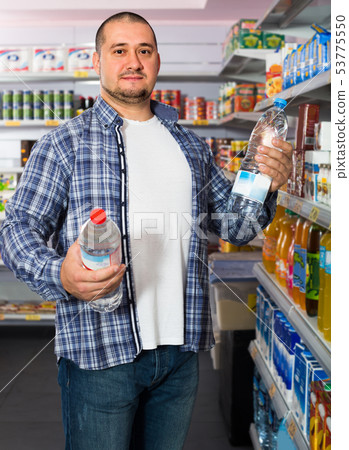 customer selecting bottle of water 53775550