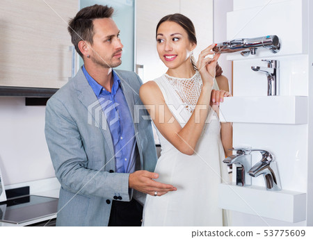 Family couple looking for modern functional mixer tap 53775609