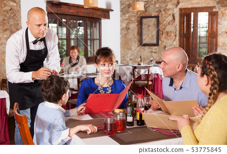 Waiter taking order of family at restaurant Waiter taking order of family at restaurant 53775845