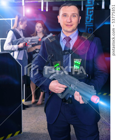 Man holding laser gun and playing laser tag Man holding laser gun and playing laser tag 53775851