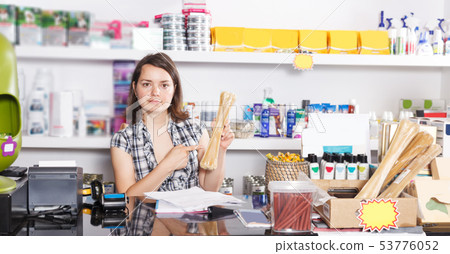 seller working with documents and goods in pet store 53776052