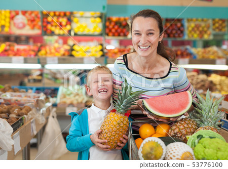 Mother and boy buying fruits Mother and boy buying fruits 53776100