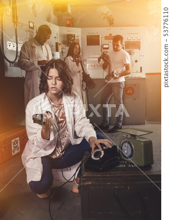 Girl talking on old telephone in quest room Girl talking on old telephone in quest room 53776110