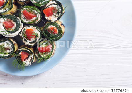 Zucchini rolls with cream cheese , tomatoes and 53776274