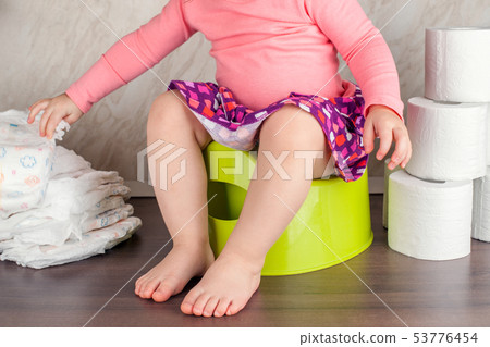 the girl sits on a green pot and learns elementary the girl sits on a green pot and learns elementary 53776454