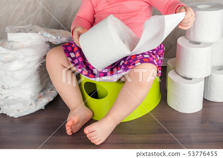 the girl sits on a green pot and learns elementary the girl sits on a green pot and learns elementary 53776455