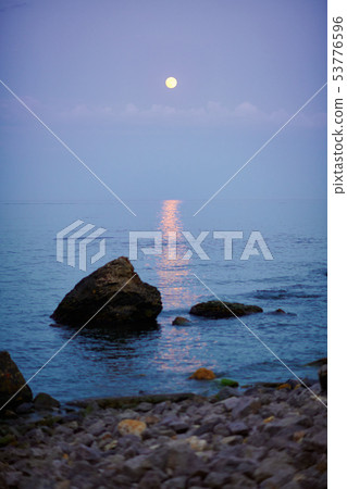 sea landscape at sunset with moon, stone coast and sea landscape at sunset with moon, stone coast and 53776596