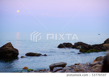 sea landscape at sunset with moon, stone coast and sea landscape at sunset with moon, stone coast and 53776597