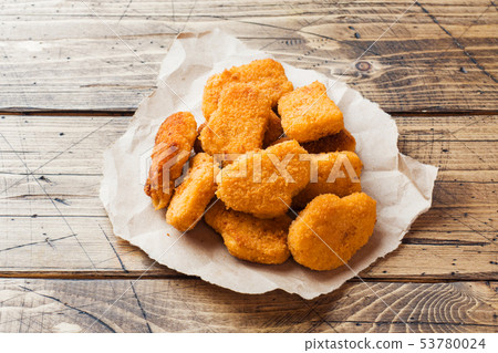 chicken nuggets with tomato sauce on wooden  53780024