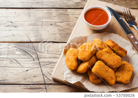 chicken nuggets with tomato sauce on wooden chicken nuggets with tomato sauce on wooden 53780026