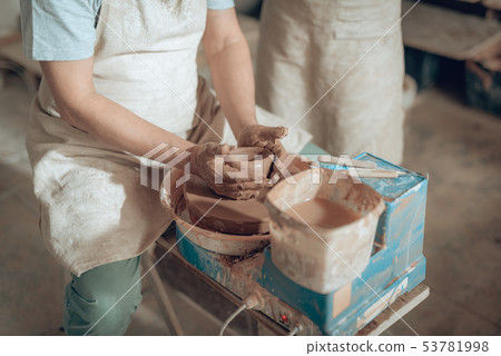 High angle of craftsman shaping earthenware in potter's studio 53781998