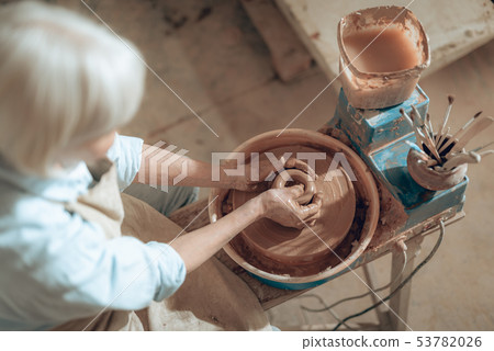 Top view of female potter shaping jug at workshop 53782026