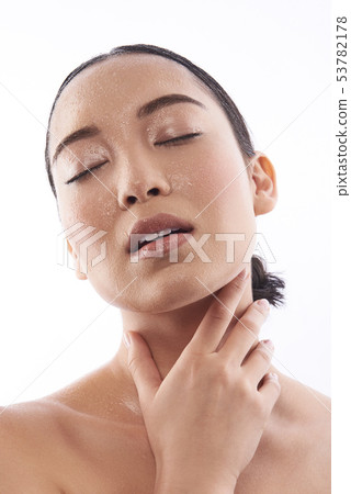 Sensual photo of Asian young woman touching her neck Sensual photo of Asian young woman touching her neck 53782178
