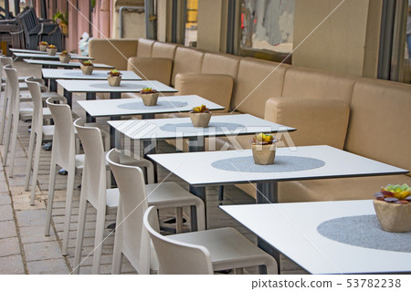 Modern cozy outdoor cafe with small tables Modern cozy outdoor cafe with small tables 53782238