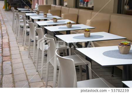 Modern cozy outdoor cafe with small tables Modern cozy outdoor cafe with small tables 53782239
