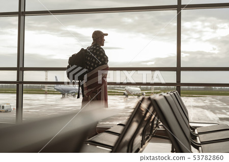 Low angle of American soldier in camouflage looking at window 53782860