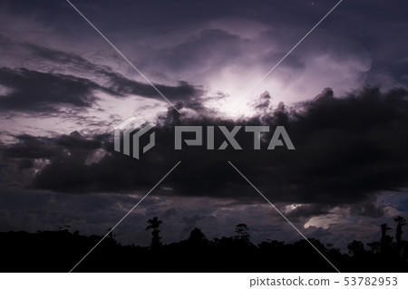 Thundercloud illuminated by lightning Thundercloud illuminated by lightning 53782953