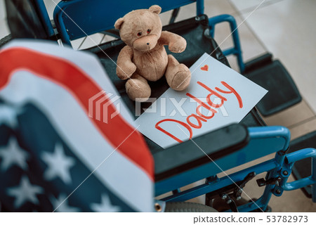 High angle of teddy bear sitting in wheelchair indoors High angle of teddy bear sitting in wheelchair indoors 53782973