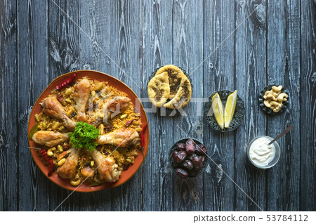 Homemade chicken Biryani on a dark background. Homemade chicken Biryani on a dark background. 53784112