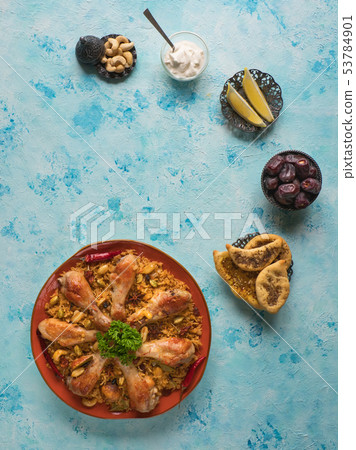 Homemade chicken Biryani on a blue background. Homemade chicken Biryani on a blue background. 53784901