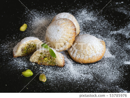 Holiday cookies stuffed with pistachios with honey Holiday cookies stuffed with pistachios with honey 53785976
