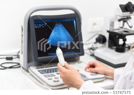 Ultrasound scanner in the hands of a doctor. Diagnostical Sonography clinic. Ultrasound scanner in the hands of a doctor. Diagnostical Sonography clinic. 53787575