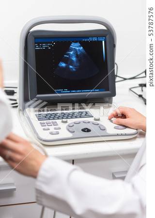 Ultrasound scanner in the hands of a doctor. Diagnostical Sonography clinic. Ultrasound scanner in the hands of a doctor. Diagnostical Sonography clinic. 53787576