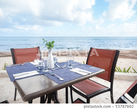 Table with dinner setting at outdoors restaurant 53787602