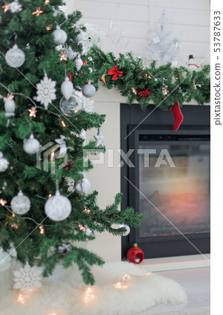 Fireplace decorated for Christmas holidays Fireplace decorated for Christmas holidays 53787633