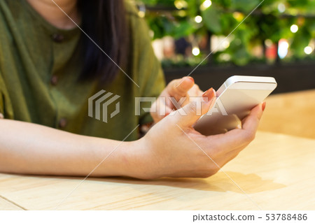 Hand of woman using smart phone. Online shopping Hand of woman using smart phone. Online shopping 53788486