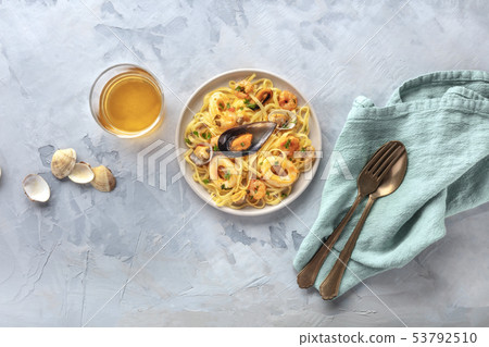 Seafood pasta. Tagliolini with mussels, shrimps, clams and squid rings, shot from the top with a Seafood pasta. Tagliolini with mussels, shrimps, clams and squid rings, shot from the top with a 53792510