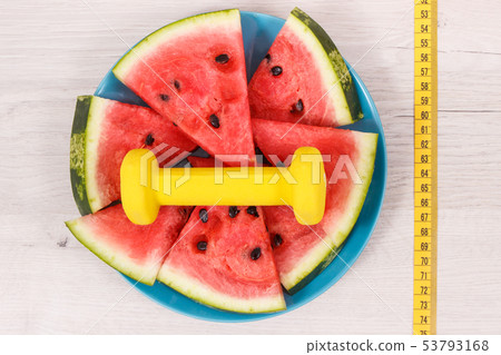 Tape measure, dumbbells and watermelon Tape measure, dumbbells and watermelon 53793168