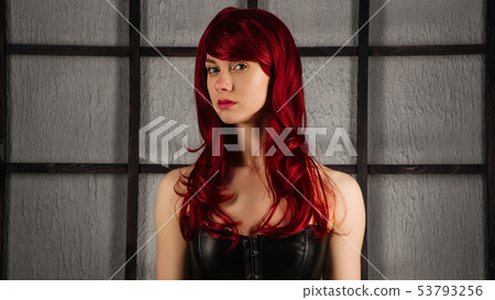 Portrait of Red-haired girl in a leather corset 53793256