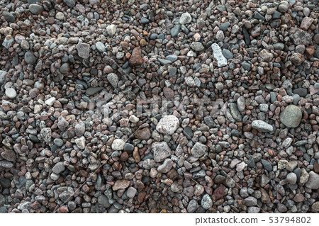 Dark pebble on a sea coast, close up photo 53794802