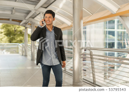 Portrait of young businessman standing at Outside Portrait of young businessman standing at Outside 53795543
