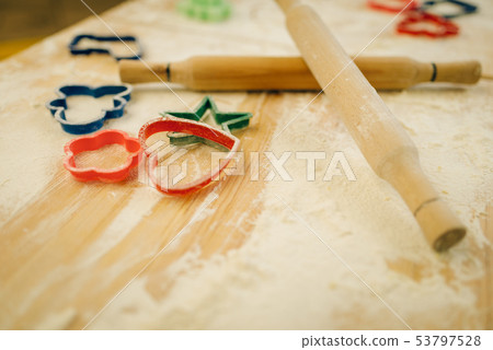 Cookie cutters, rolling pin and flour on table Cookie cutters, rolling pin and flour on table 53797528