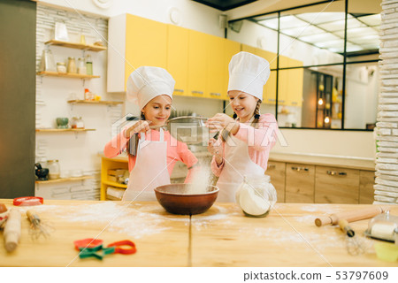 Girls cooks, cookies preparation on the kitchen 53797609