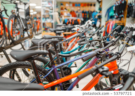 Rows of bicycles in sports shop, focus on seat Rows of bicycles in sports shop, focus on seat 53797721