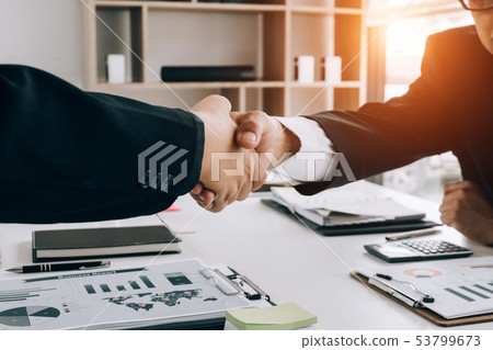 Business people partners shaking hands after 53799673