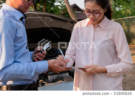 Insurance agent writing document on clipboard Insurance agent writing document on clipboard 53800826