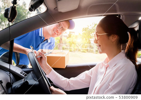 Delivery man service delivering package box to 53800909