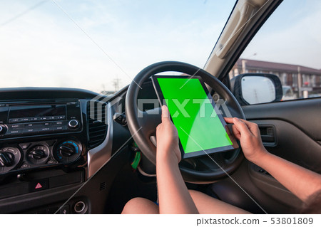 Hand of woman using tablet with blank green screen 53801809