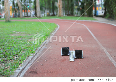 Athletics Starting Blocks and red running tracks 53803192